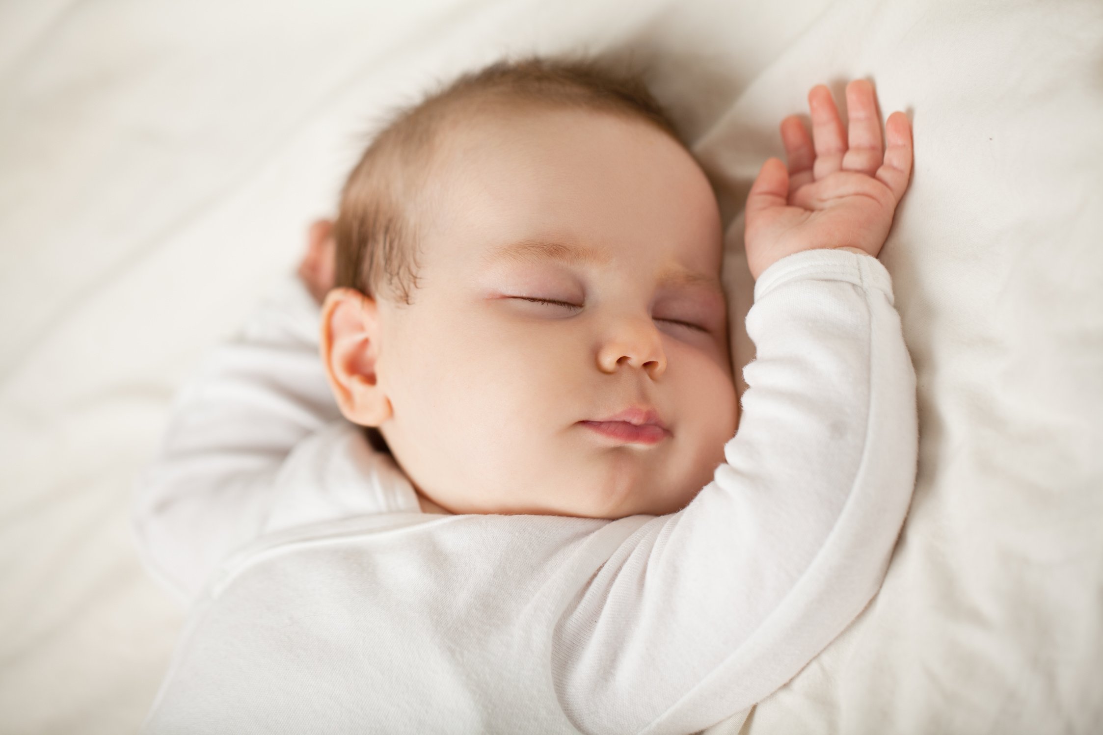 Sleeping newborn baby on white background. Small sleeping child, bedtime (baby up to one month)